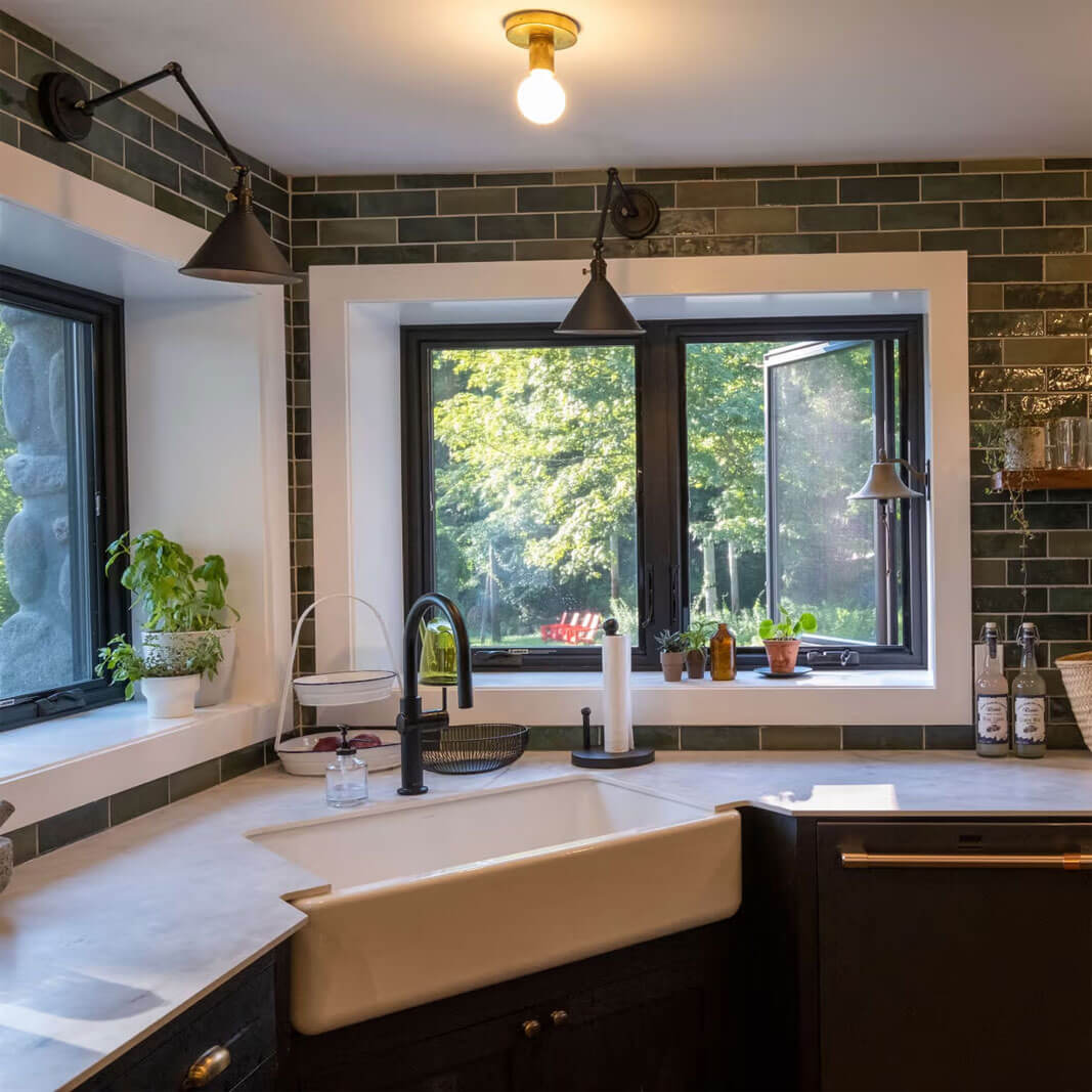 Black casement windows above a kitchen sink
