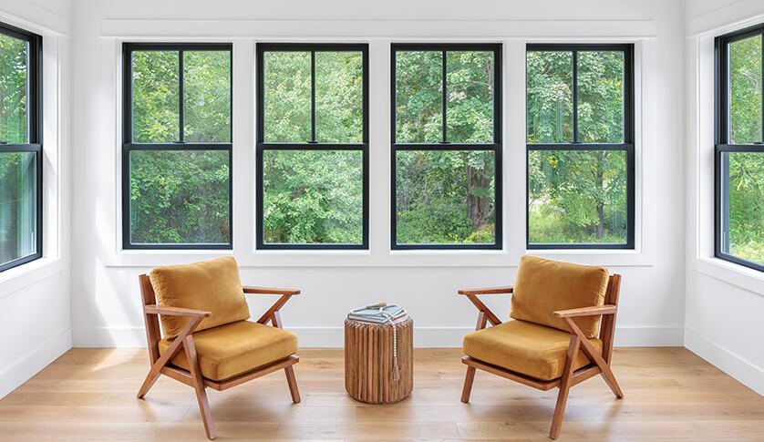 Bright living room with a row of black double-hung windows
